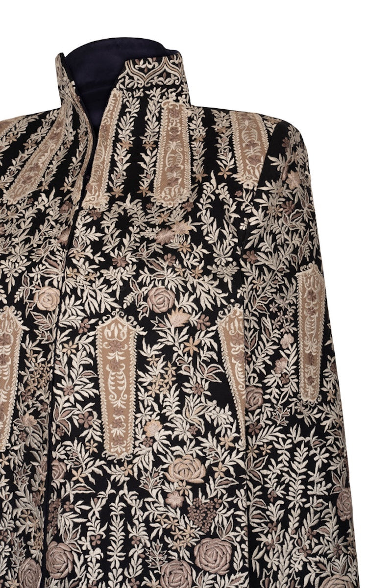 Nadya Shah Astrid in Byzantine cape jacket with intricate gold and navy embroidery, detailed close-up of the luxurious fabric and design.