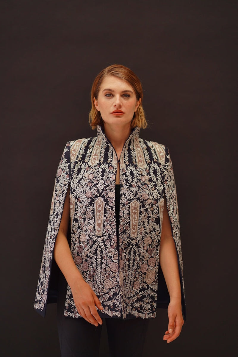 Nadya Shah Astrid in Byzantine cape jacket with intricate embroidery, flowing fabric, and detailed design featuring Byzantine-inspired patterns.