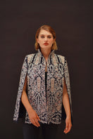 Nadya Shah Astrid Byzantine Cape jacket featuring intricate Byzantine-inspired patterns and elegant draping in rich fabric.