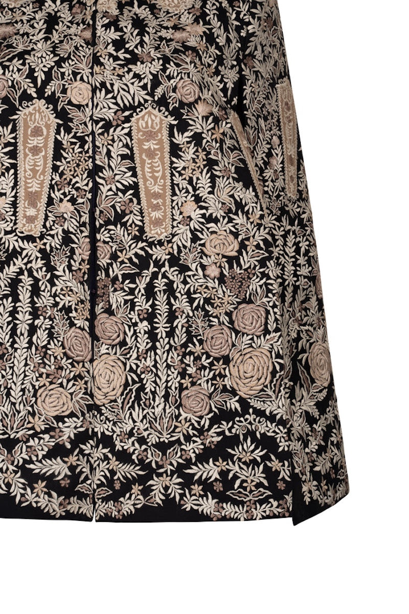 Close-up of Nadya Shah Astrid in Byzantine cape jacket showing intricate Byzantine-inspired embroidery and detailed fabric texture.