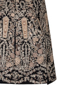 Nadya Shah Astrid in Byzantine cape jacket with intricate embroidered details and flowing fabric, showcasing elegant bohemian style.