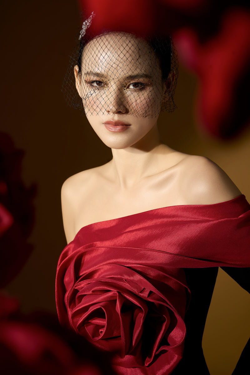 Red I.H.F rosette crepe and taffeta gown featuring an asymmetric column design with draped rose detail.