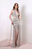 Rayane Bacha Athéa Gown in silver, elegant evening dress with intricate detailing and flowing fabric, perfect for formal occasions.