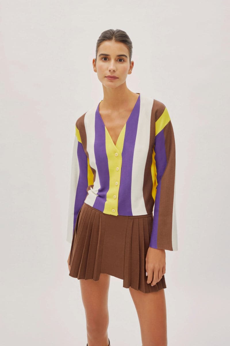 Labeca Athena cappuccino pleated mini skirt displayed on a hanger with soft fabric folds and a stylish, modern design.