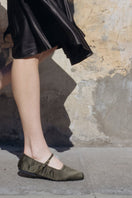A pair of AERA Aurora gold crystal military satin ballerina flats with decorative crystal embellishments and satin finish.