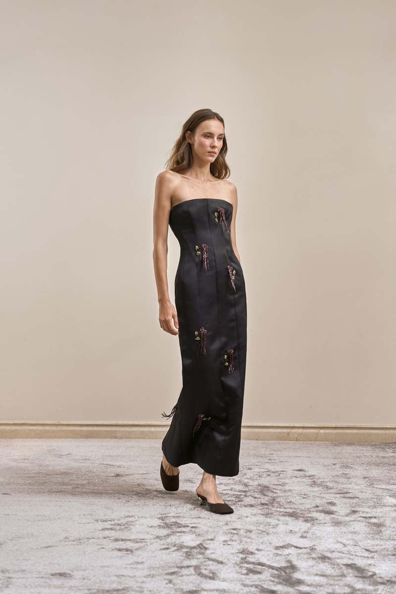 Black Axis Gown midi dress by Yassmin Saleh, shown from a side view, featuring a sleek, elegant silhouette and smooth fabric.