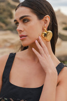 Jessica K B.O Cora Gold Earrings, shiny hoop earrings with elegant design, showcased on a neutral background.
