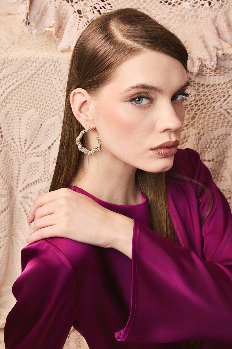 Jessica K B.O ISLA earrings featuring stylish hoop design with intricate detailing, perfect for elegant accessory wear.