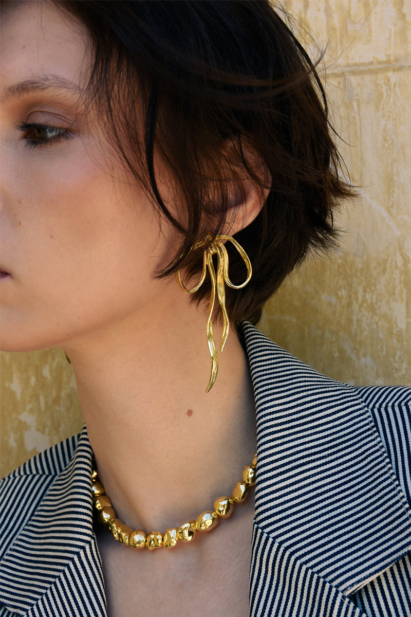 Jessica K B.O Julie earrings featuring stylish hoop design with intricate detailing and gold-tone finish.