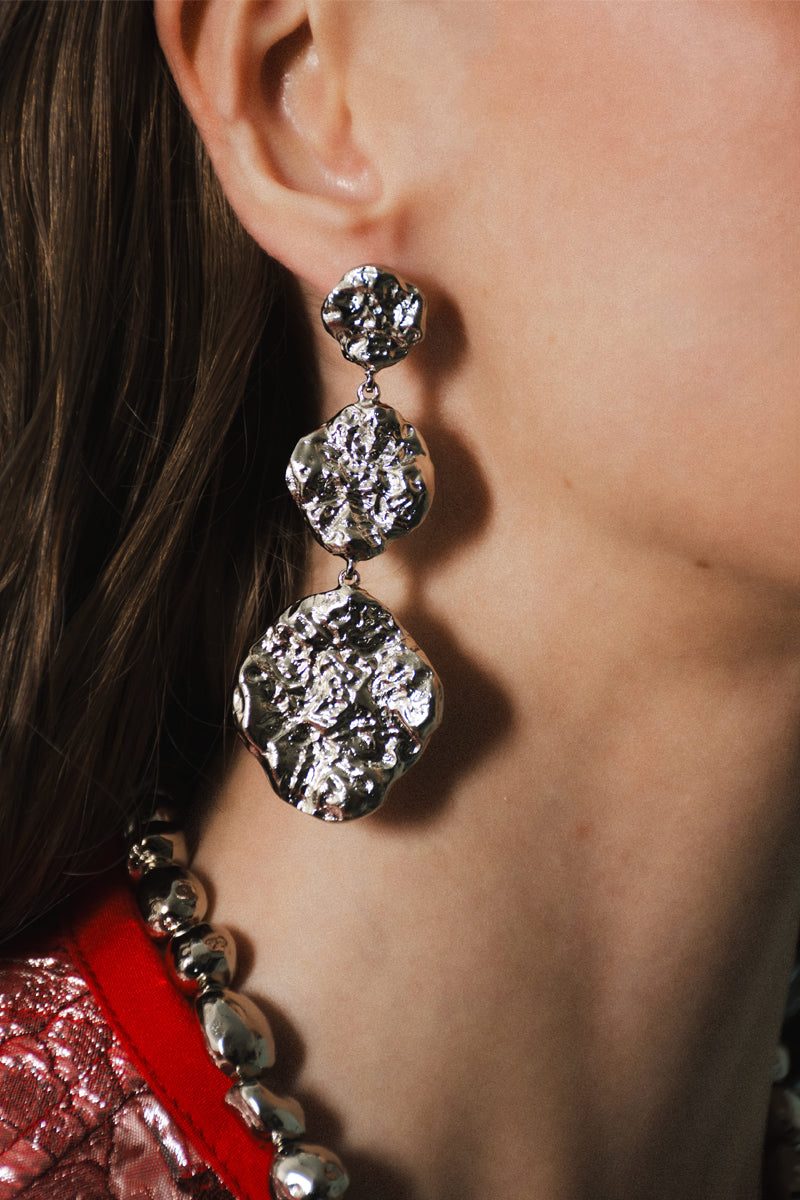 Silver B.O Zuri earrings by Jessica K featuring sleek, modern design with polished finish, displayed on a plain background.