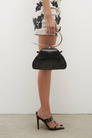 Black leather BOMBON top handle bag with Murano glass handle from JC Pajares, stylish and elegant accessory.