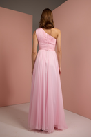 Baby pink one-shoulder gown by Joanna Andraos, shown from the back with flowing fabric and elegant design.
