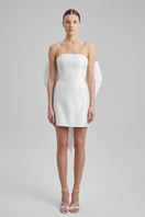 White mini dress by BAÉ featuring a large bow at the waist, perfect for stylish daytime or evening wear.