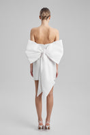 White BAÉ mini dress with a large bow at the waist, featuring a feminine and stylish design.