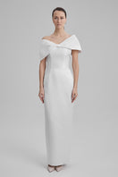 White maxi dress by BAÉ featuring shoulder bows, flowing fabric, and elegant design perfect for summer or special occasions.