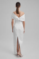 White maxi dress with shoulder bow from BAÉ, featuring flowing fabric and elegant design, perfect for summer or special occasions.