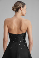Black BAÉ gown from EVE DIAMONDS collection, elegant floor-length dress with intricate detailing and luxurious fabric.