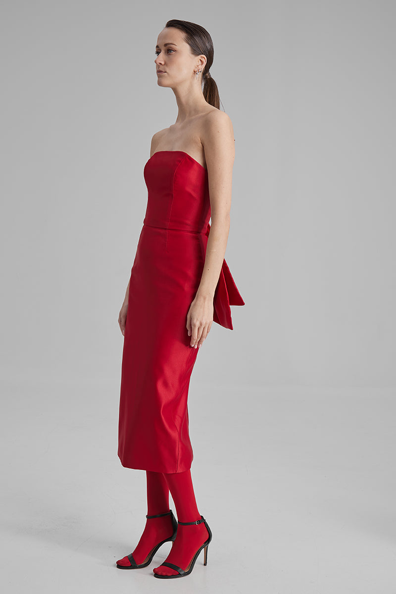 Red KIRA midi dress by BAÉ featuring a side bow, elegant midi-length design, perfect for stylish occasions.