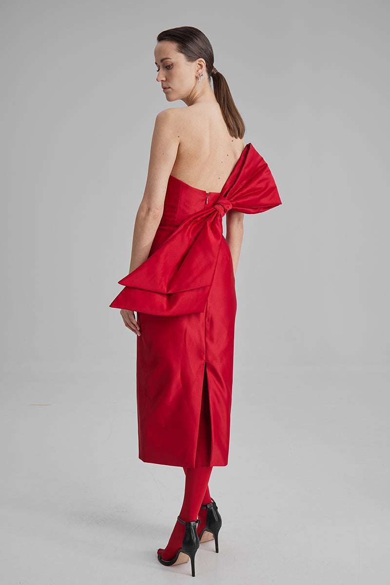 Red midi dress by BAÉ featuring a side bow, elegant sleeveless design, perfect for stylish occasions.
