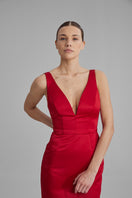 Bright red BAÉ maxi dress with flowing fabric and sleeveless design, perfect for summer or formal occasions.