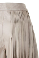 Ivory baggy leather fringe pants by MAZ Manuela Álvarez with relaxed fit and fringe details, shown on a model.