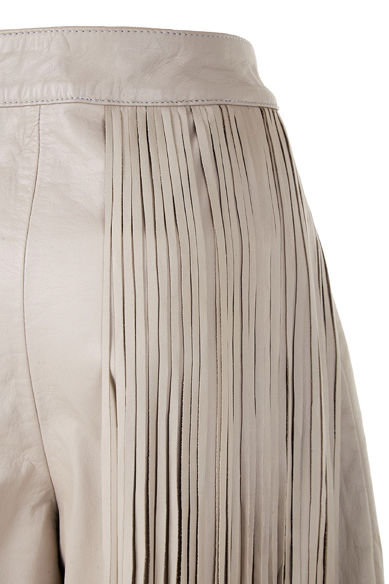 Ivory baggy leather fringe pants by MAZ Manuela Álvarez with relaxed fit and fringe details, shown on a model.