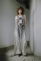 Ivory baggy leather fringe pants by MAZ Manuela Álvarez with relaxed fit and fringe details, displayed on a hanger.