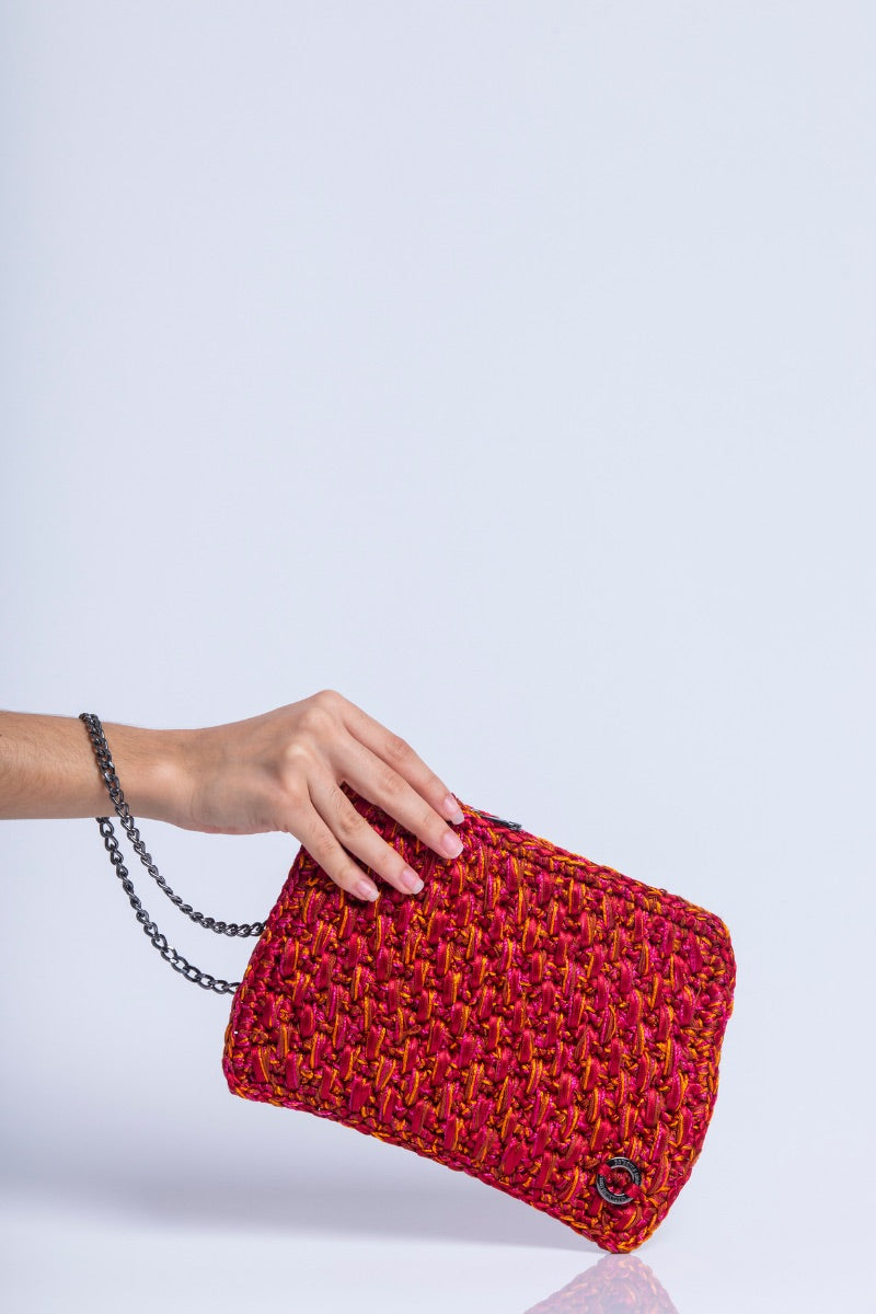 Catarina Mina Brisa clutch bag in vibrant grape orange with a sleek design, perfect for stylish evening accessories.