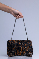 Catarina Mina Brisa clutch bag in black and brown leather with sleek design and subtle stitching details.