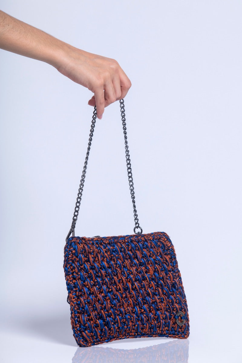 Catarina Mina Brisa terrablue clutch bag with a sleek design and textured finish, perfect for elegant evening accessories.