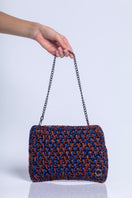 Catarina Mina Brisa terrablue clutch bag with woven texture and sleek design, perfect for elegant occasions.