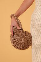 Catarina Mina concha top handle bag in sandy color, featuring a stylish shell design and elegant leather strap.