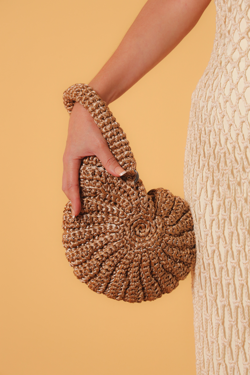 Catarina Mina concha top handle bag in sandy color, featuring a stylish shell design and elegant leather strap.