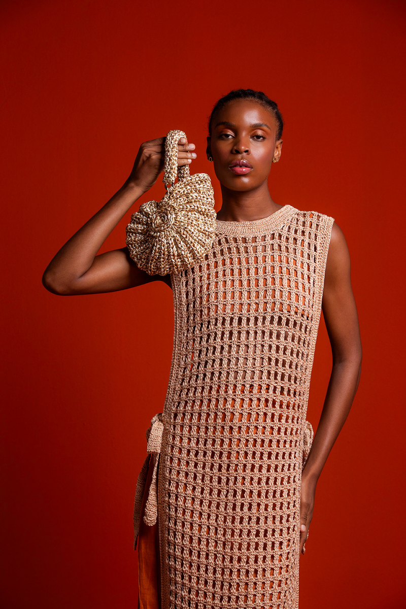 Catarina Mina concha top handle bag in sand color with woven texture and rounded shape on a neutral background