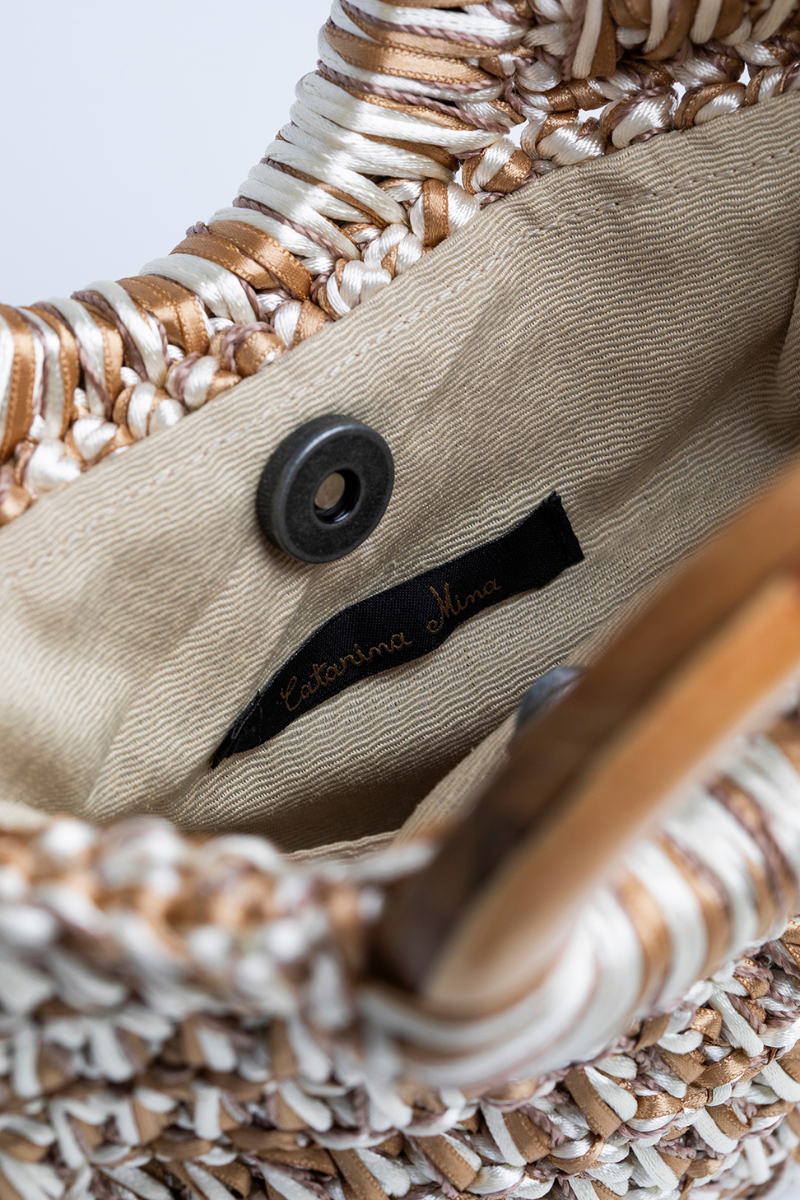 Catarina Mina Danza nude-beige top handle bag with sleek design and structured silhouette.