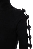 Black BASIC BOWS sweater by MAZ Manuela Álvarez, featuring a classic knit design and bow accents, shown in a close-up view.