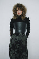 Black BASIC BOWS sweater by MAZ Manuela Álvarez featuring a classic design and soft knit fabric, displayed on a neutral background.