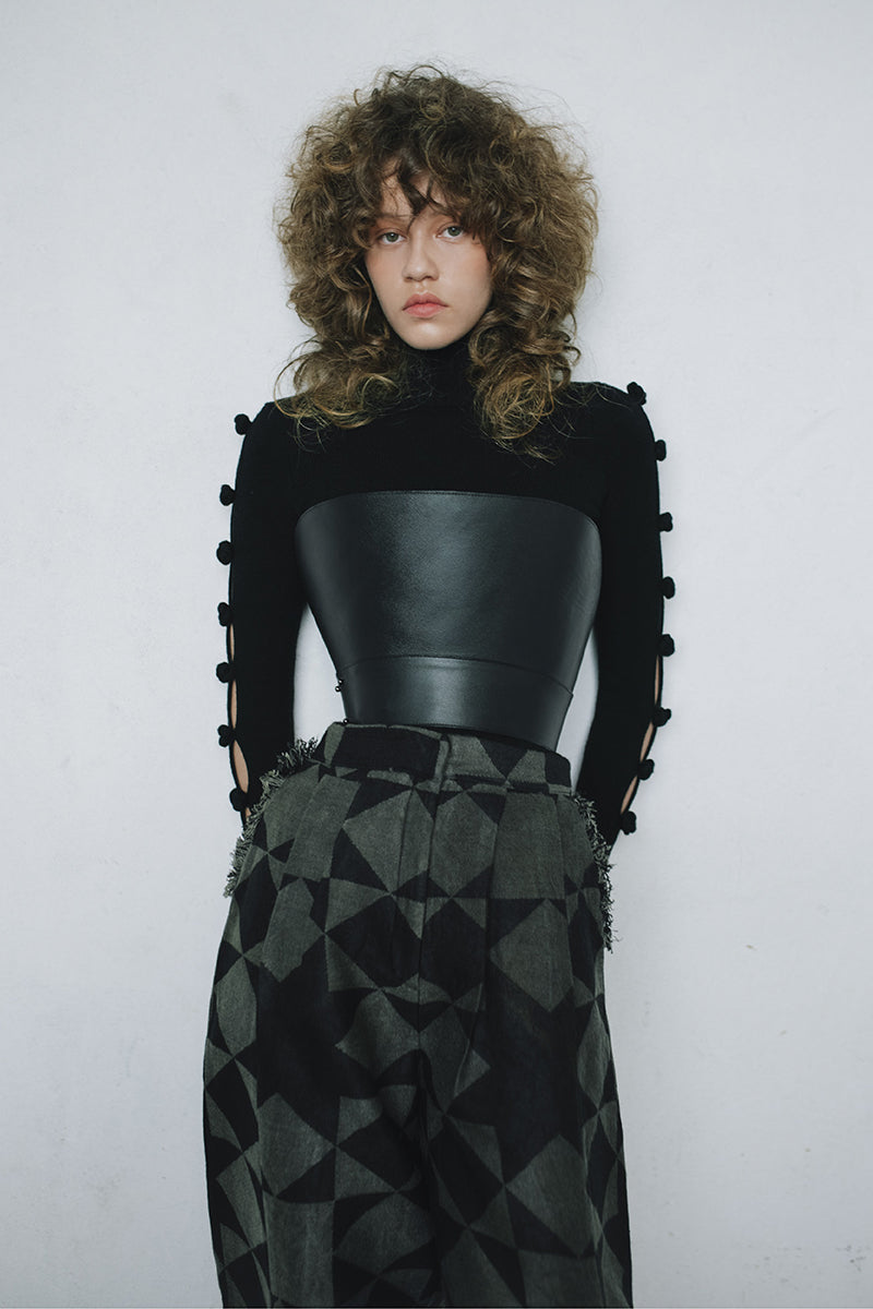 Black BASIC BOWS sweater by MAZ Manuela Álvarez featuring a classic design and soft knit fabric, displayed on a neutral background.