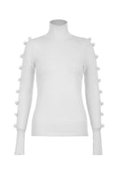 White MAZ Manuela Álvarez BASIC BOWS sweater, shown on a hanger with a close-up of the soft knit fabric and bow detail.