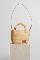 Beige raffia basket bag with top handle from Folklore The Label, perfect for casual and summer outings.
