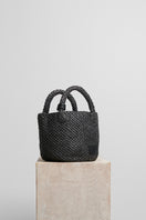 Black raffia basket bag with top handle from FolkLore The Label, showcasing a woven design perfect for casual or stylish outings.