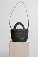 Black raffia basket bag with top handle from Folklore The Label, showcasing woven texture and elegant design.