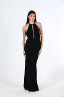 Aquarel Studio black Stella maxi dress displayed on a hanger with flowing fabric and elegant design.