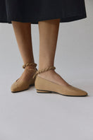 Alta Aria almond flats shown on a background, featuring beige almond-colored slip-on flats with a sleek design.
