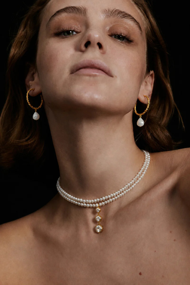 Peracas Bianca hoops earrings in ivory, gold-tone hoop jewelry with a sleek, polished finish, showcasing elegant and versatile design