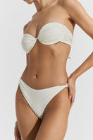 Seaquelle creme white billow bikini top and twisted bikini bottom, stylish swimwear set on a plain background