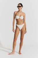 Seaquelle white bikini top and twisted bikini bottom styled together, featuring a sleek, minimalist design for beachwear.