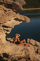 Black Talia Collins Christy swimsuit with sleek design, featuring a fitted silhouette and stylish straps for a modern swimwear look.