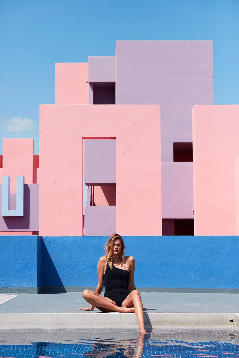 Black reversible asymmetrical swimsuit by Talia Collins featuring a stylish one-shoulder design and textured fabric.
