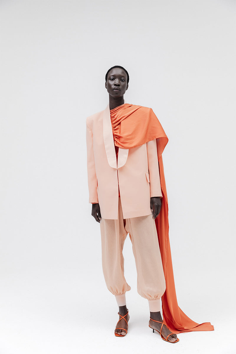 Studio NK ETHERAL peach blazer, stylish tailored blazer with a sleek fit, shown in a vibrant peach color.